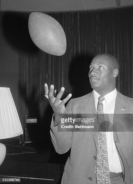 Bo Jackson, Heisman Trophy winner from Auburn, flips a football as he meets with the press following his being picked first in the NFL draft by the...
