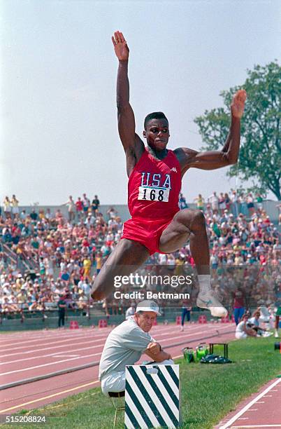 Indianapolis: Carl Lewis flies through the air in the long jump at Pan American Games. Lewis set a new Pan American record with a jump of 28 feet 8...