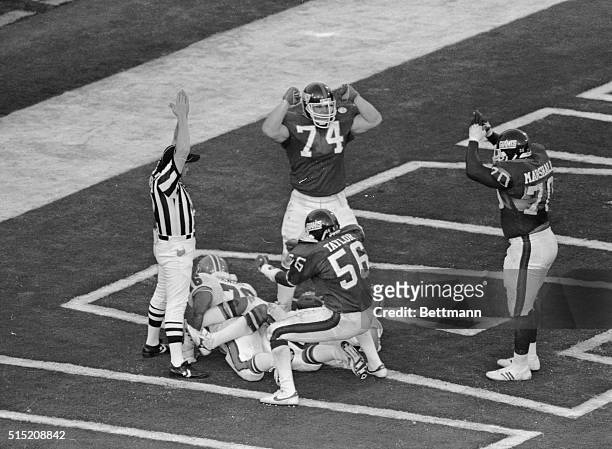 Lawrence Taylor, and Leonard Marshall celebrate here, after sacking Denver's John Elway for a down during the Superbowl.