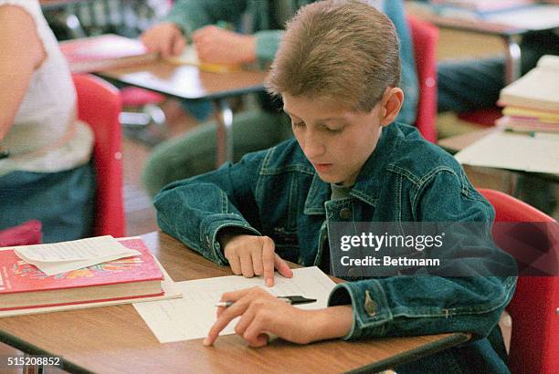 Freshman Ryan White works on a math assignment at Hamilton Heights High School in Arcadia, Indiana, on his first day of the new school year. White, a...