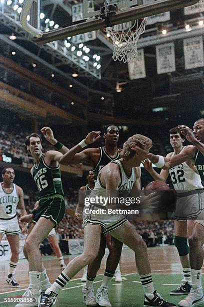 Celtics' Larry Bird goes up between Bucks' Jerry Reynolds and Craig Hodges for basket in the 1st quarter of the second game of the NBA semifinals at...