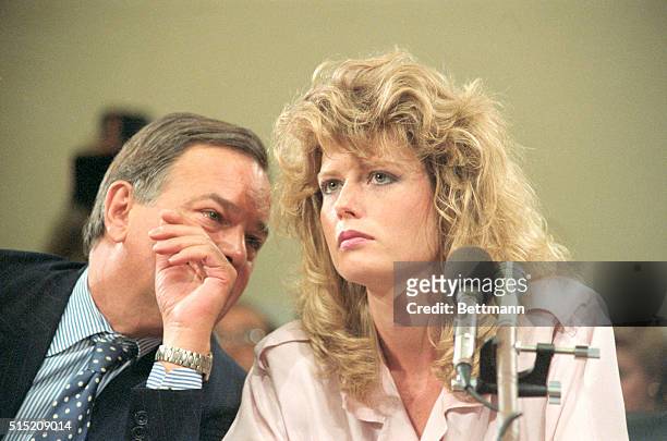 Washington: Fawn Hall, former personal secretary to Lt. Col. Oliver North, listens to Plato Cacheris, her attorney, during the House and Senate...