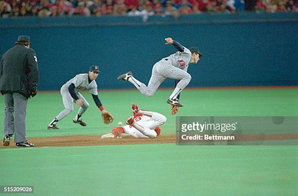 St. Louis: The Cardinals' Vince Coleman slides head first into 2nd with a third inning steal, as the low throw from catcher Tim Laudner skips past a...