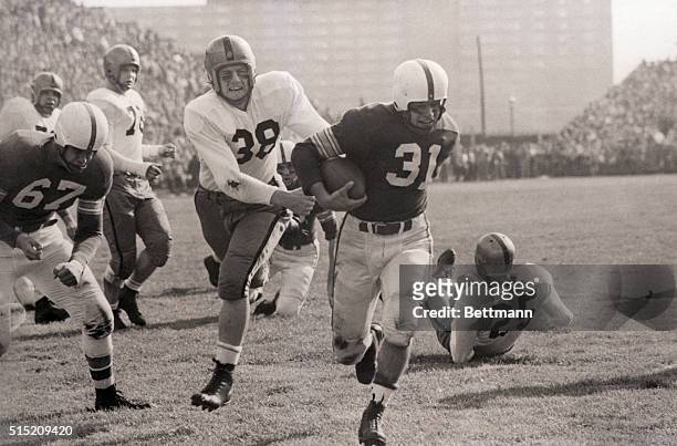 Columbus, OH- Vic Janowicz of Ohio State, goes over from the 11-yard line for State's first touchdown against Iowa. Duane Brandt of Iowa trails...