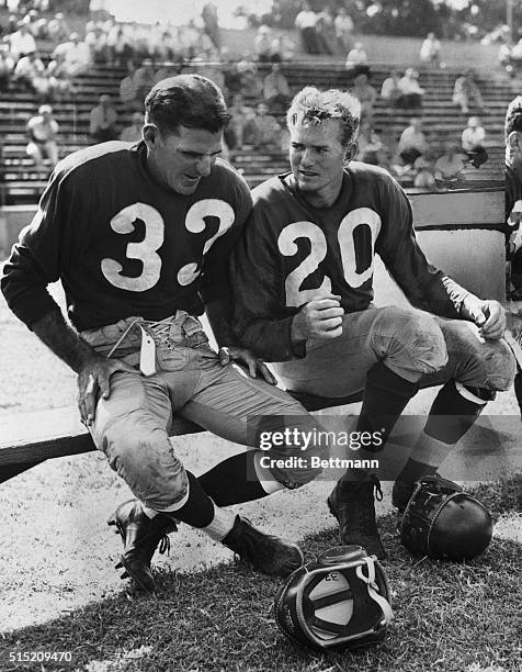 Sammy Baugh chuckles on the bench over a yarn told by Harry Wismer during a lull in a scrimmage at the Washington Redskins training camp at...