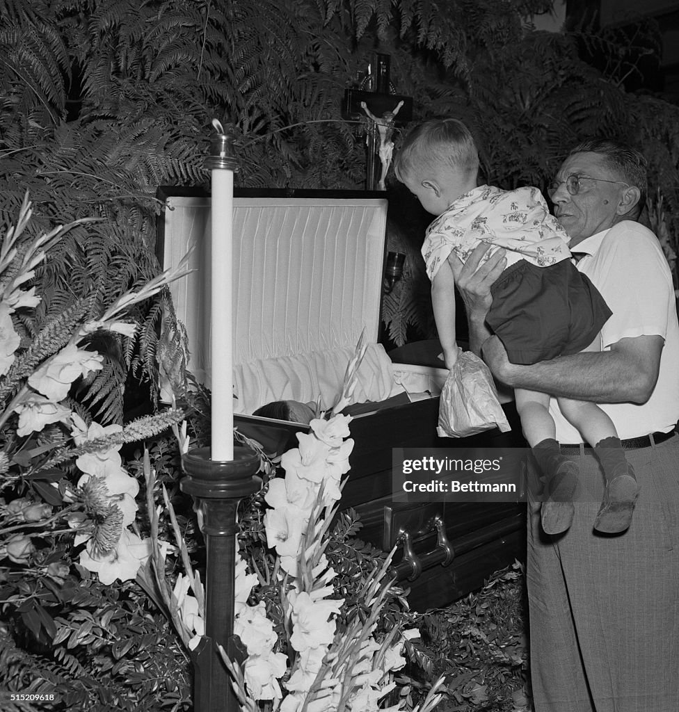 Baby Ruth Case A sight to remember...One of Babe Ruth's admirers holds his young son ...