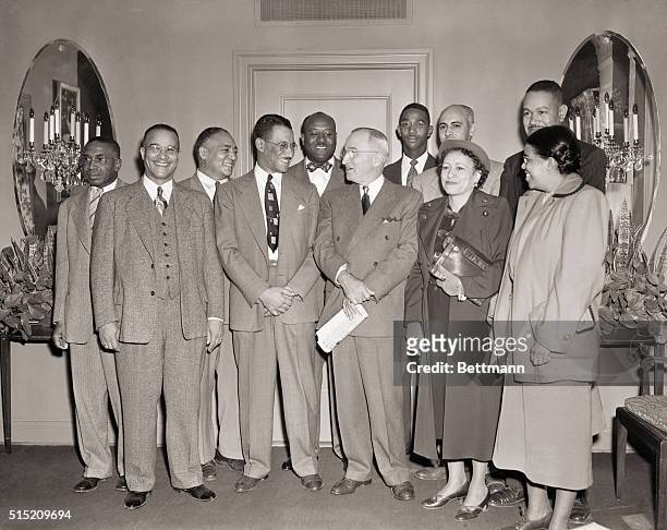 Kansas City, MO- President Truman stands with a group of Kansas city Negroes, who invited him to address the December 27th Tri-Convention of 3 negro...