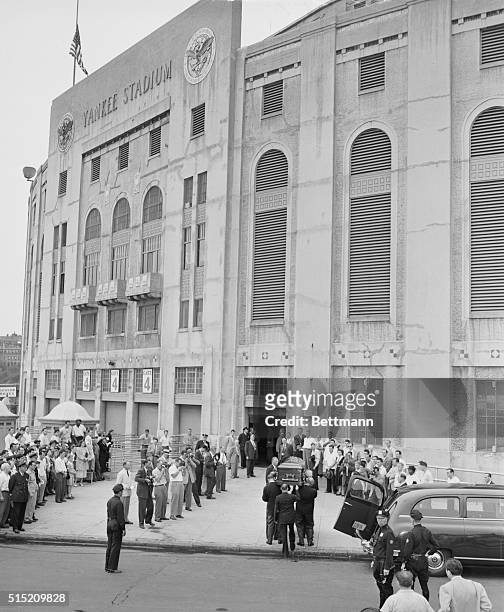 The Babe comes home...Pall bearers carry the body of Babe Ruth into the Yankee Stadium, "The House That Ruth Built," August 17th. It will lie in...