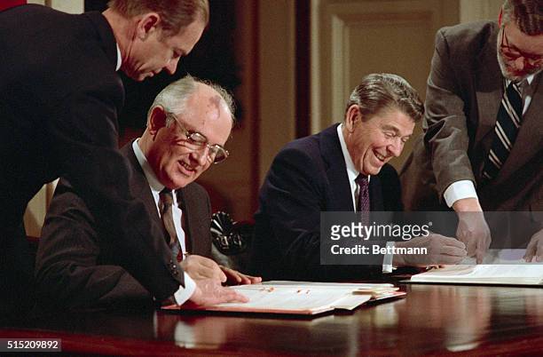 President Ronald Reagan and Soviet leader Mikhail Gorbachev signing the arms control agreement banning the use of intermediate-range nuclear...
