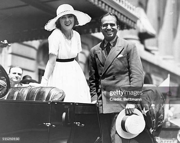 Mary Pickford and Douglas Fairbanks Sr. Standing with automobile. Undated photograph.