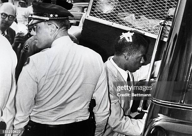 Jackson, MS: With the Adhesive tape "X" still on his head, marking the spot where he was struck in racial violence at Montgomery, Alabama, John...