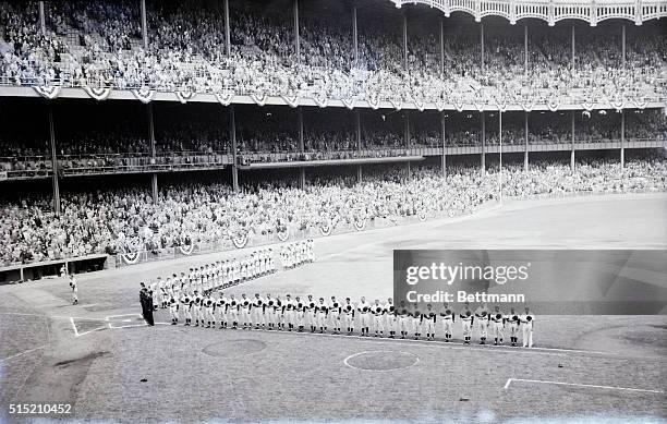 New York, NY: Lined up in a victory "V", the New York Yankees and their World Series opponents, the Philadelphia Phillies, stand in silent tribute to...