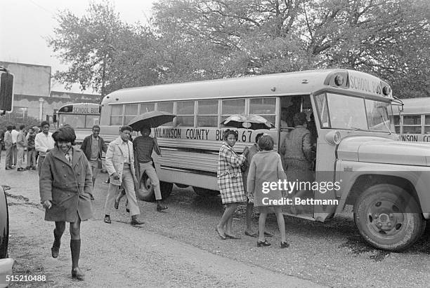 Black students in Woodville, Mississippi board a school bus for their first day at a formerly white school that, thanks to "white flight", has become...