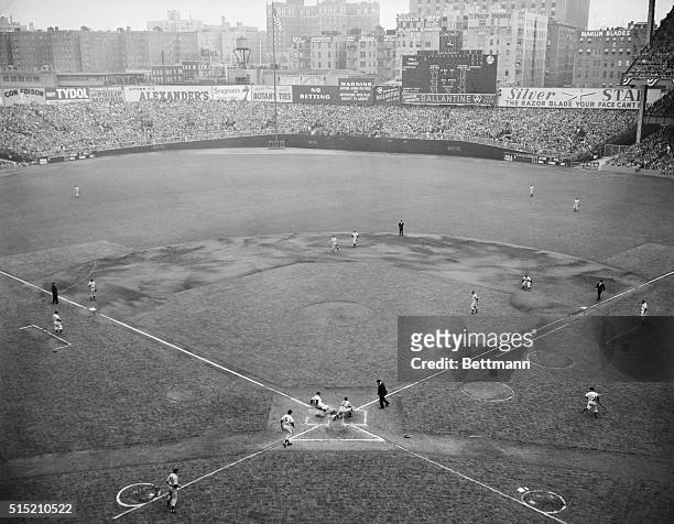 New York, NY:Gen. View of Yankee Stadium shows Yank Gene Woodling sliding into home plate in first inning of the 4th World Series Game,the game's...