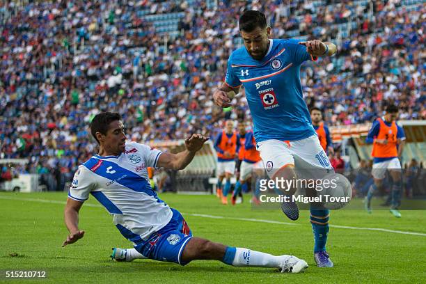 Ariel Rojas of Cruz Azul fights for the ball with Patricio Araujo of Puebla during the 10th round match between Cruz Azul and Puebla as part of the...