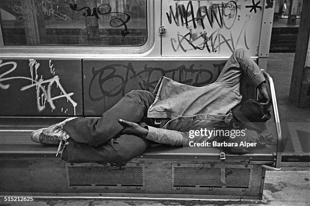 Man sleeping in a subway carriage, New York City, 9th June 1980.