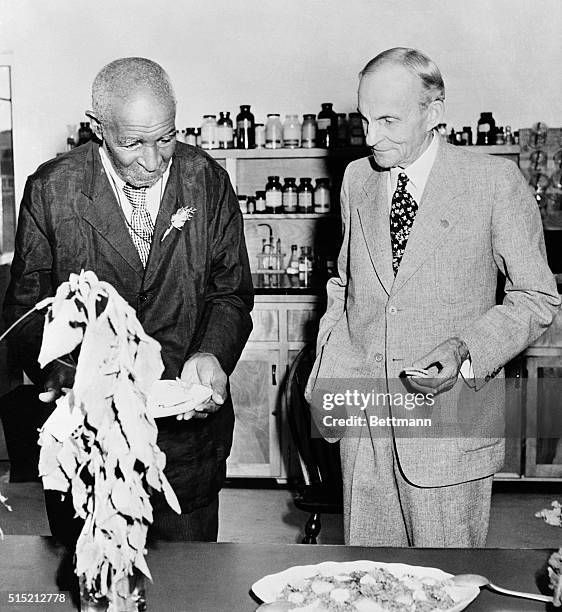 Dr. George Washington Carver with Henry Ford after being presented with a modern, fully equiped laboratory for food research, a gift from Mr. Ford.