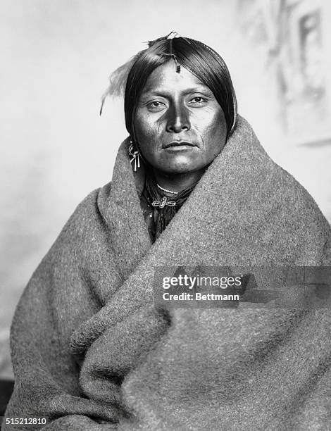 Waist-up portrait of a Comanche buck. Undated photograph.