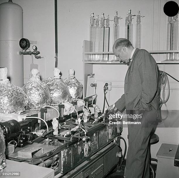 Berkeley, CA- Nobel Prize-winning chemist Dr. Melvin Calvin inspects Chlorella growing tanks in his laboratory. Chlorella is an organism used for...