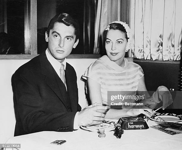 New York- Ava Gardner, glamorous movie star, is shown with textile millionaire Bob Evans at the Harwyn Club last night. Miss Gardner's divorce suit...