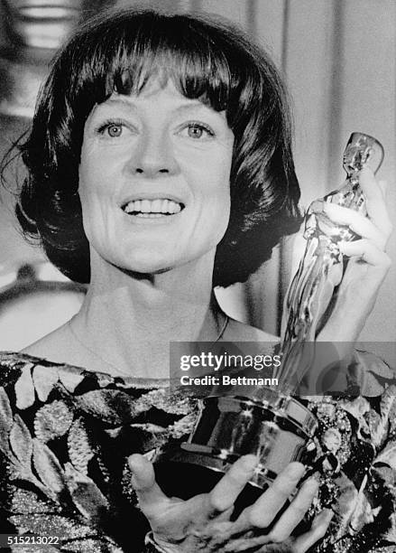 Hollywood, CA: Actress Maggie Smith is all smiles as she holds up her "Oscar" which she won as Best Actress in a Supporting Role at the 51st Annual...