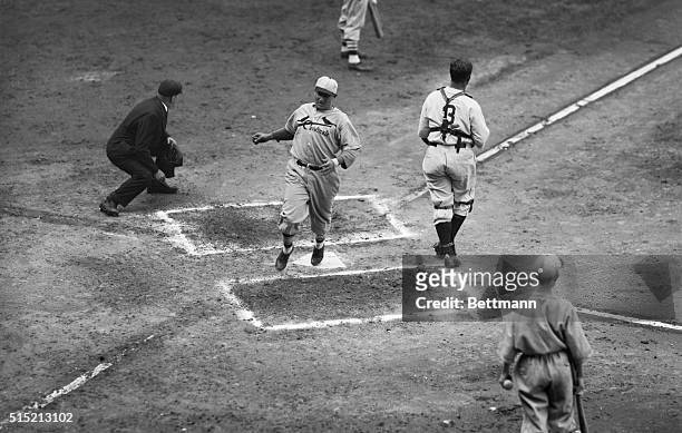 Detroit, MI: St. Louis catcher Bill De Lancey scores on Ernie Orsatti's triple in the second inning of the second World Series game with Detroit. The...