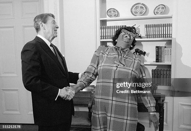 Washington, D.C.- Entertainer Pearl Bailey throws back her head in laughter as she talks with President Reagan in the Oval Office. Ms. Bailey, the...