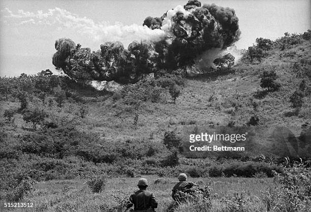 An Ke, South Vietnam - Soldiers of the 101st Airborne Division move through valley northwest of Qui Nhon after a napalm bomb, dropped by support...