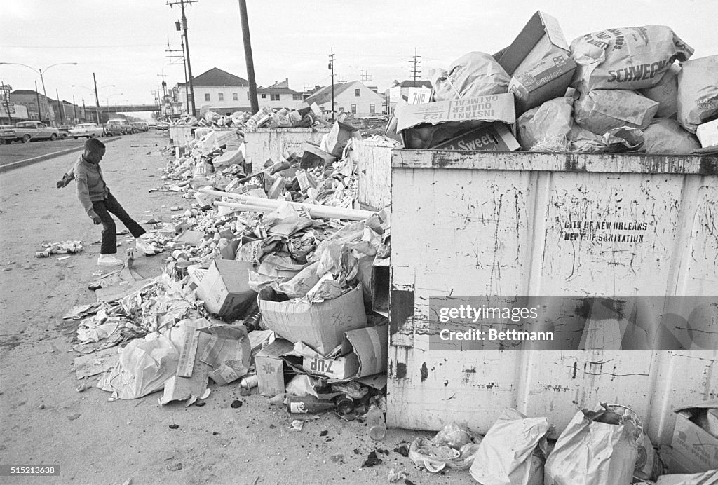 Boy Kicking Trash at Dumpsters