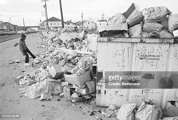 New Orleans, Louisiana- A small boy kicks a can onto the heap of garbage along Orleans St., near the city auditorium 1/23, on the fourth day of a...