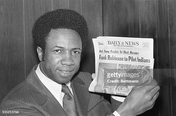 New York, NY- Frank Robinson, Baltimore Orioles' super star, displays newspaper whose headline predicts, Aug. 7, he'll be named manager of the...