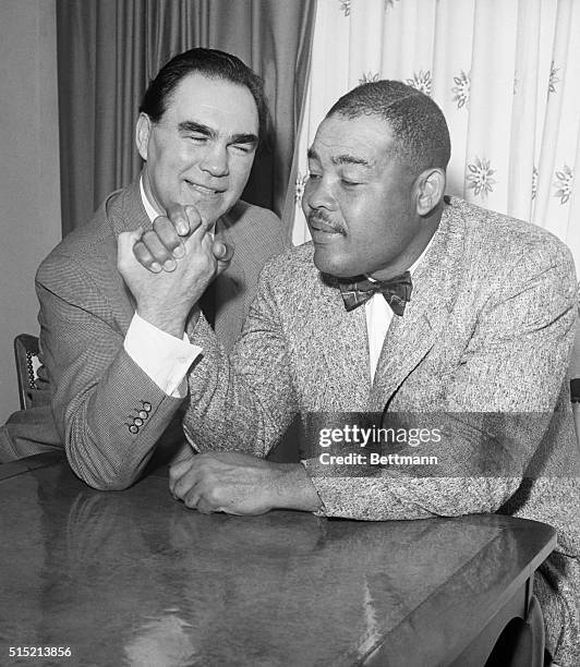 Miami Beach, FL: Ex-heavyweight boxing champs Max Schmeling and Joe Louis got together at Miami Beach early 3/2 for a reunion. The two are shown here...
