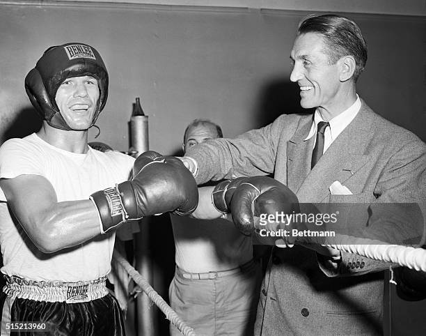 New York, NY - Georges Carpentier , who flew here yesterday to help train Marcel Cerdan, takes a good look at Tony Zale as the latter started...