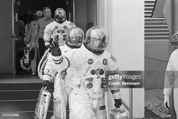 The Apollo 13 crew travel from the suiting station to a van that will transport them to the rocket site