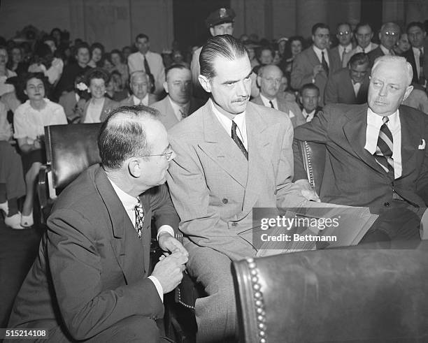 Washington, D.C.- Howard Hughes, center, charged under oath today that Sen. Owen Brewster, of ME., offered to call off the Senate probe of his...