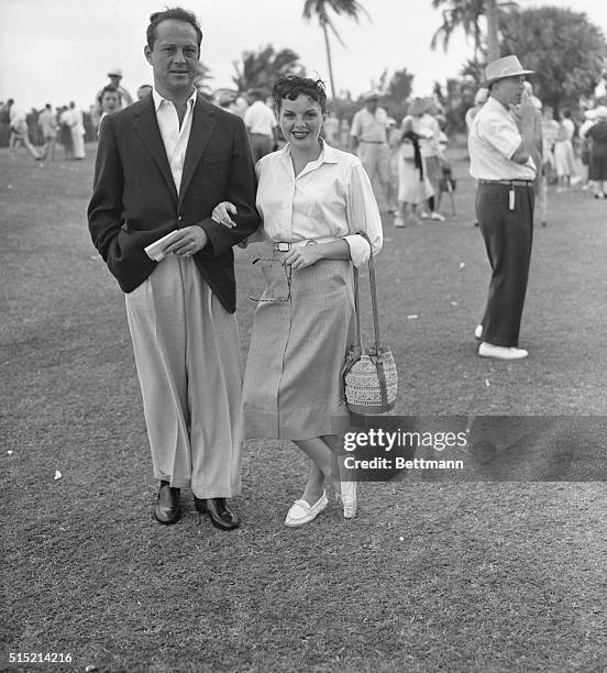 West Palm Beach, FL- Screen star Judy Garland and her fiance Sidney Luft pause in the sun at the Seminole Golf Club. Miss Garland is vacationing...
