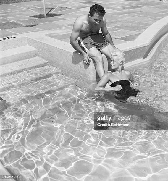 Lake Kiamesha, NY- Jake La Motta cools his feet with his wife, Vickie, during training at Lake Kiamesha. The world middleweight king will meet Rocky...