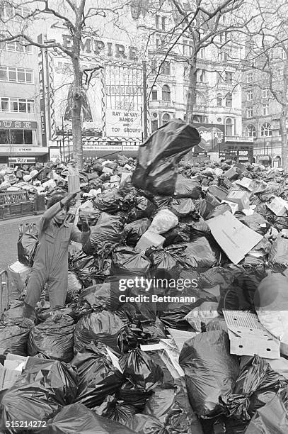 London, England- Leicester Square, in the West End of London, is crowded with bags of rubbish 2/5 as it is designated a "council refuse centre" durng...