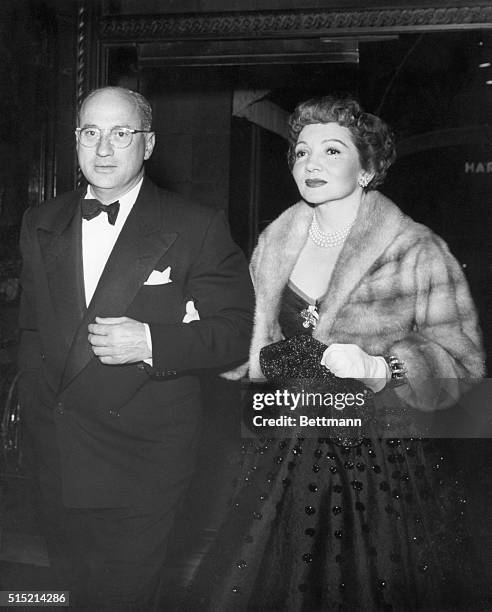 Dr. Joel Pressman and Claudette Colbert entering the Beverly Wilshire Hotel to attend the party Louis B. Mayer gave in honor of Henry Ford II and...