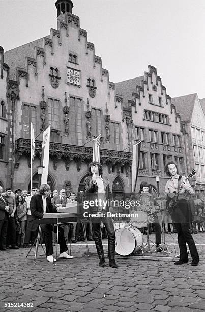 Frankfurt, Germany- Jim Morrison, leader of "The Doors" singing group, with bandmates, performing outside the Town Hall today for the taping of a...