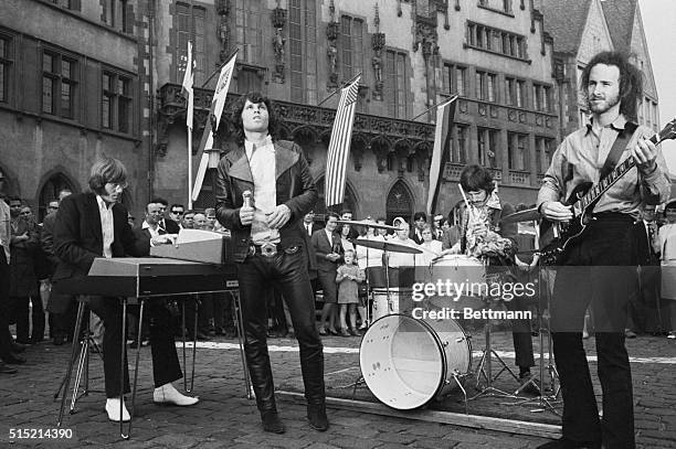 The Doors perform outside the Frankfurt town hall for German television.