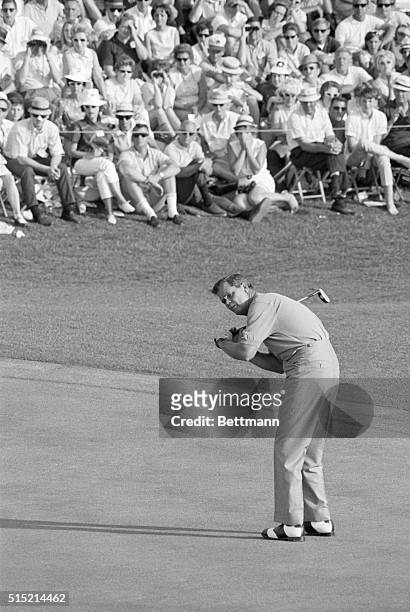 Augusta, GA- Gay Brewer, Jr. Flexes his putter like a baseball bat as he lines up his next-to-final putt on the 18th green of the Augusta National...
