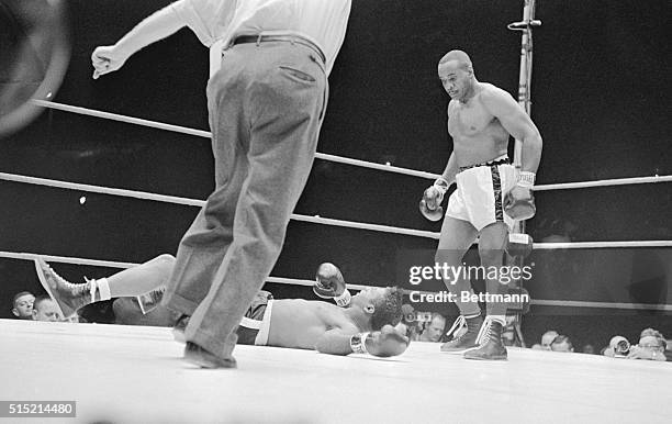Comisky Park, Chicago, IL - Sonny Liston watches as Floyd Patterson falls to the canvas after being hit by a hard left hook in the first round of...