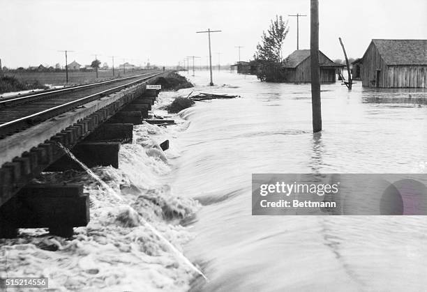 Shaw, MS-Photo shows the wild flood waters rushing about a railraod trestle on the Yazoo, a Mississippi Valley Railroad. This photo was taken shortly...