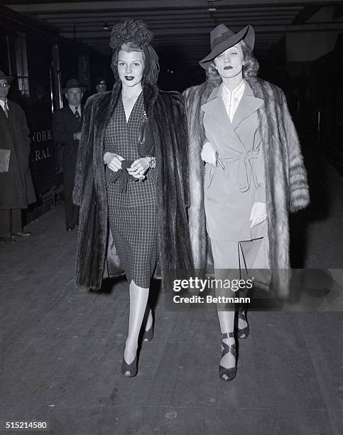 New York, NY-Rita Hayworth and Marlene Dietrich, Columbia Pictures glamour stars, depart for Hollywood after a New York visit, during which they...