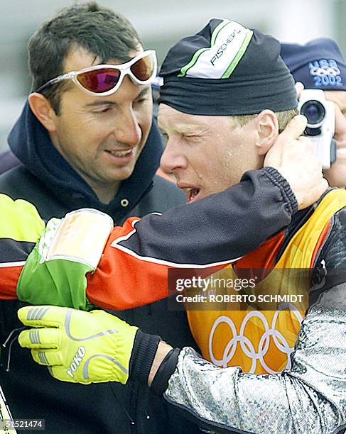 An exhausted Johann Muehlegg of Spain rests after finishing the Men's 50km Classical Cross Country ski race 23 February 2002 at the XIX Winter...