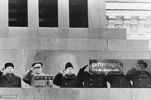 Moscow, Soviet Union: Russian leaders unite as they review a parade from the rostrum of the Lenin-Stalin Mausoleum in Red Square, on the 39th...