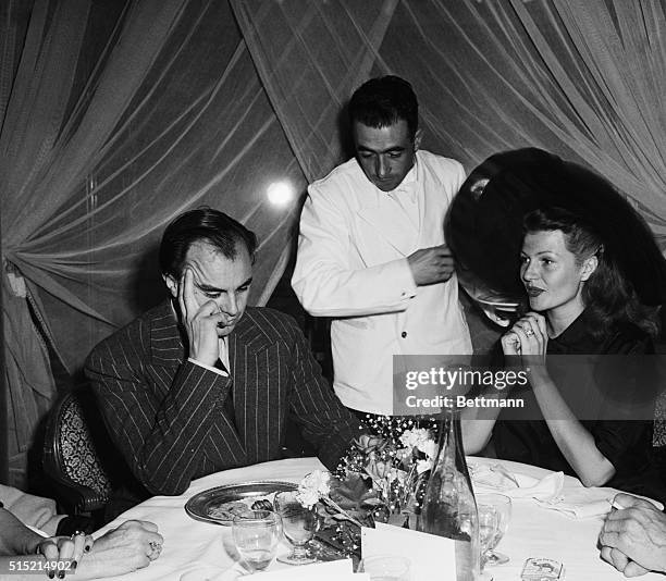 Paris, France-Prince Aly Khan and his wife, actress Rita Hayworth, order lunch at the annual "Festival of Drags" luncheon at the George V Hotel in...