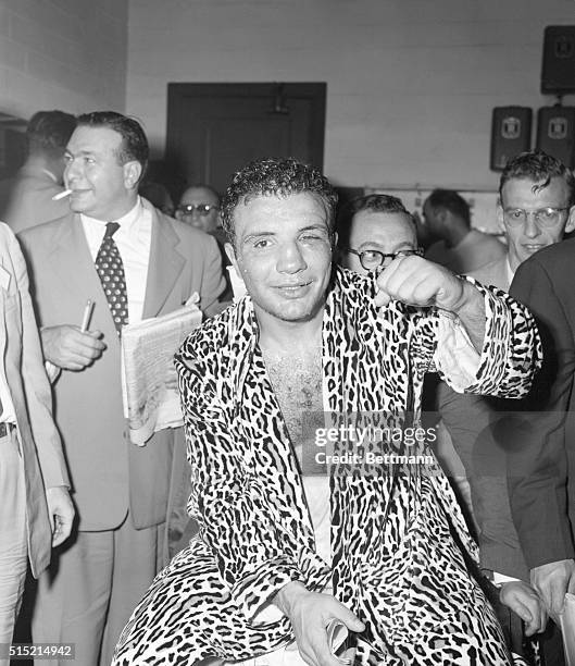 Detroit, MI- Jake La Motta, still middleweight champ by grace of his left hook, shows the fist to the camera after his 15th round knockout of...