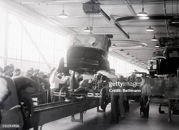 Edgewater, New Jersey- A Ford body about to be placed on its chassis, one of later and important operations in the making of a Ford. This is one of...